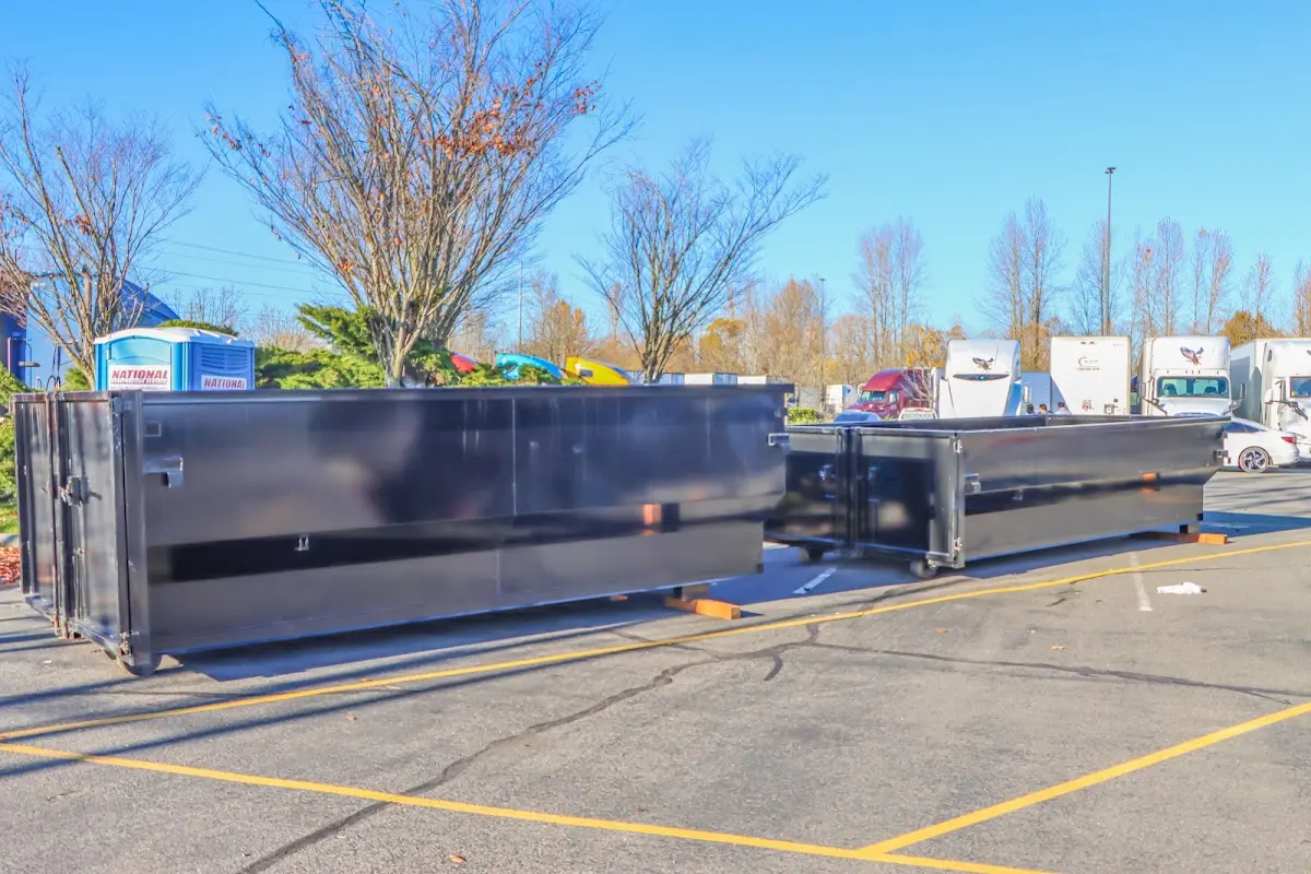 Professional dumpster rental service with roll-off container on residential driveway in Powdersville